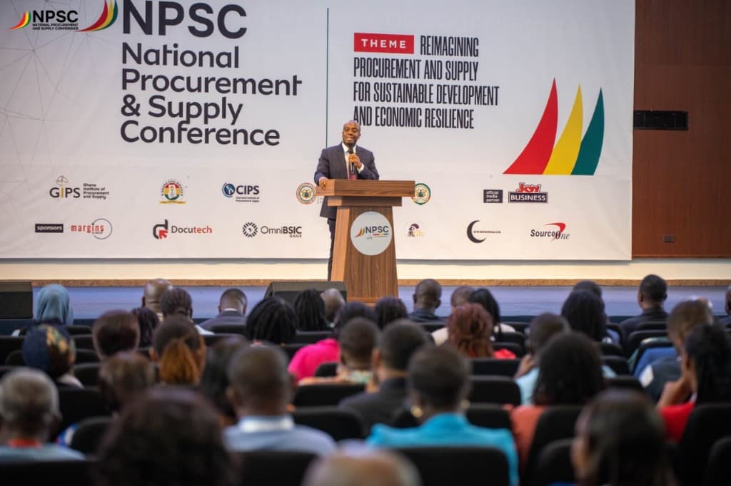 Keynote speaker on stage with the audience seated in the hall